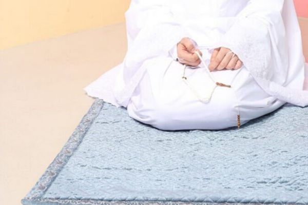 Why I Converted To Islam - Woman kneeling down on grey carpet